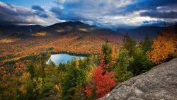 Amazing Big Autumn Forest and Small Lake in Mountain Valley