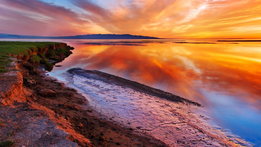 Amazing Wonderful Orange Sunset on the Lake and Beach