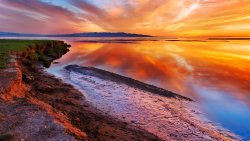 Amazing Wonderful Orange Sunset on the Lake and Beach