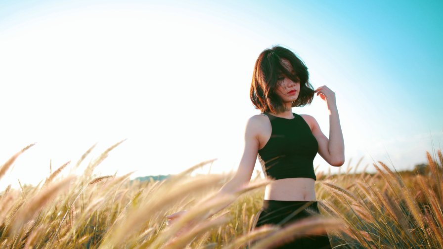 Beautiful Asian Girl in Black Top in a Field