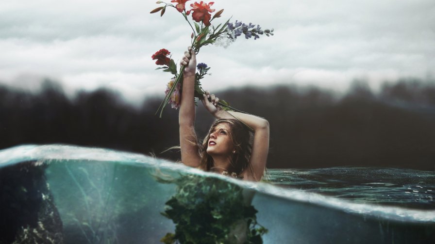 Beautiful Blonde Girl in Water with Flowers