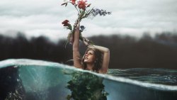 Beautiful Blonde Girl in Water with Flowers