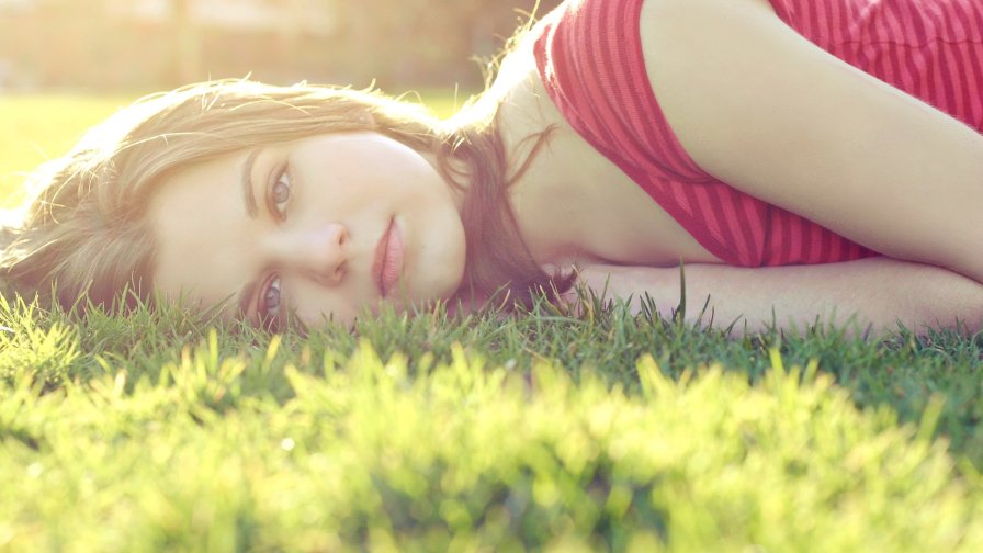 Beautiful Blonde Teen Girl on the Green Grass