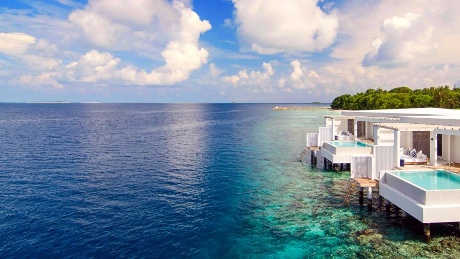 Beautiful Blue Sea and Single House on the Beach