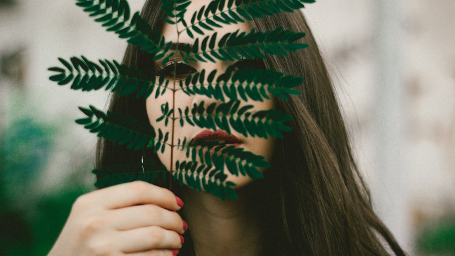 Beautiful Girl with Big Green Leaf