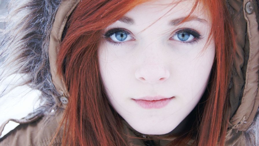 Beautiful Girl with Red Hair and Snowflakes