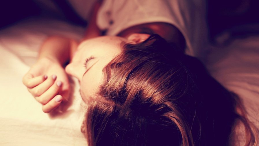 Beautiful Sleeping Girl on the Bed