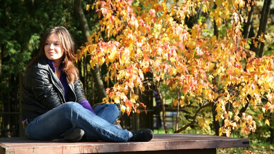 Beautiful Young Girl in Autumn Garden