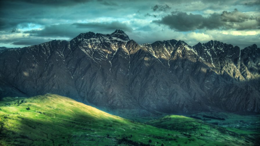 Clouds in the Sky Mountains and Green Grass