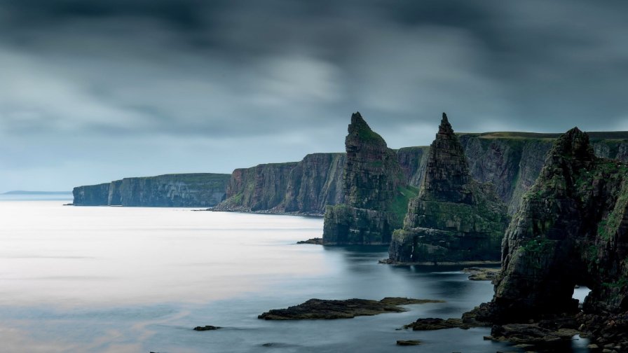 Coast and Rocks with Waves of Sea