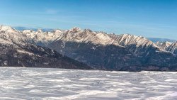 Empty Snow Covered Meadow and Mountains