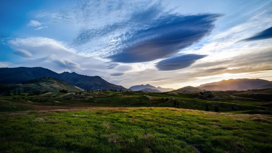 Green Field Clouds in Sky and Mountains