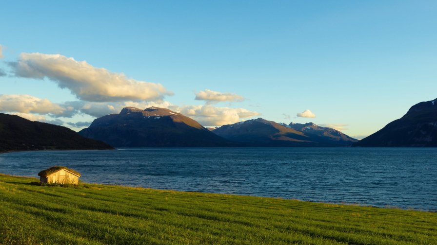 Lake in Mountain Valley Green Grass and Hills in Norway