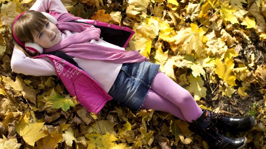 Little Girl on the Yellow Autumn Leaves