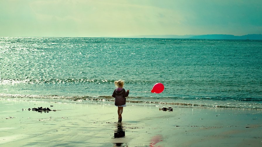 Little Girl with the Balloon on The Beach