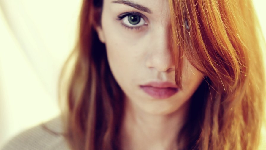 Pretty Sad Girl with Red Hair and Green Eyes