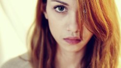 Pretty Sad Girl with Red Hair and Green Eyes