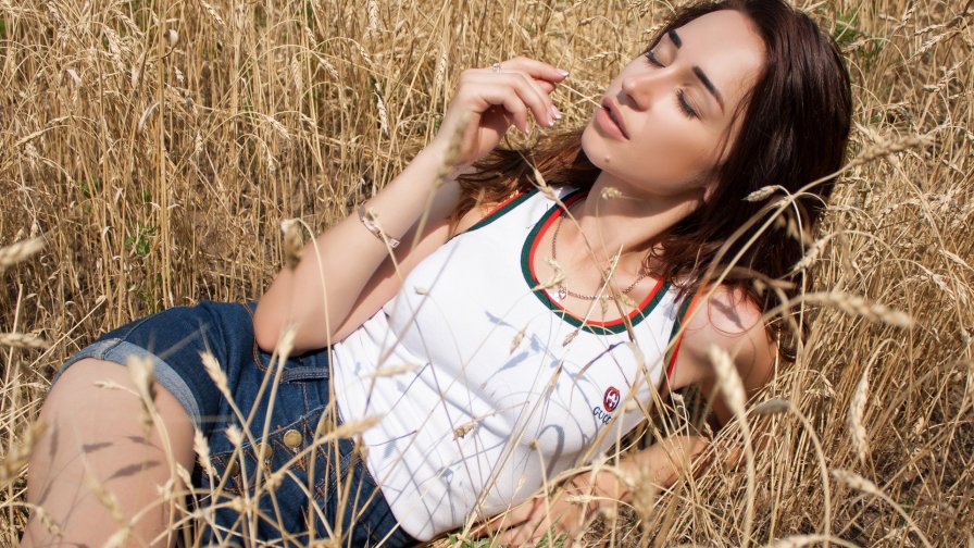 Pretty Young Brunette Girl on the Wheat