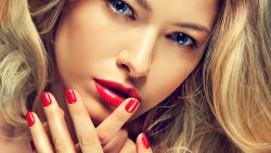 Pretty Young Girl with Blue Eyes Beautiful Lips and Red Manicure