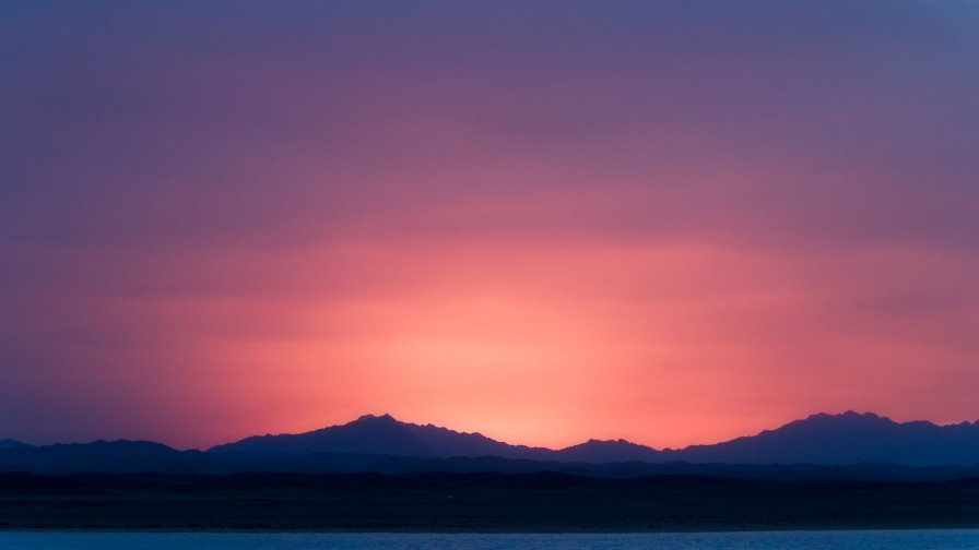 Purple Sunlight Mountains Peaks and Lake