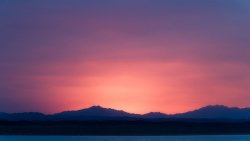 Purple Sunlight Mountains Peaks and Lake