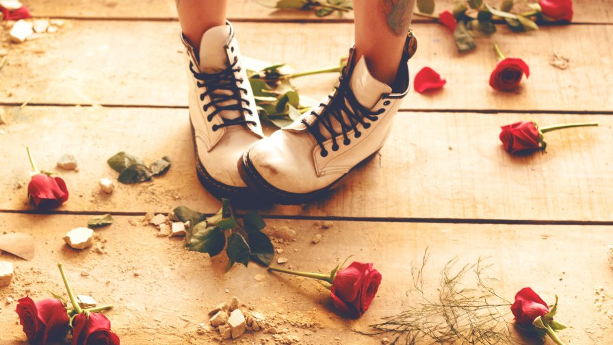 Shoes and Sad Teen Girl with Red Roses on the Floor