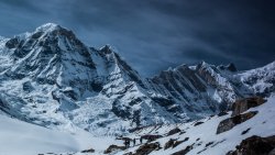 Snow Covered Mountain Peaks and Tourists