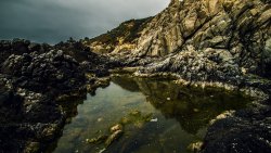 Stone Beach with Water and Village