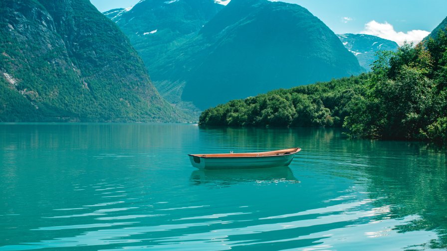 Boat and Beautiful Blue River in Mountain Valley